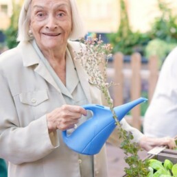 Resident watering the garden at our yorkshire care home