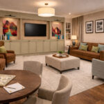 Artist's impression of a TV lounge with sofa, armchairs and a games table at Elland Court Care Home, Leeds