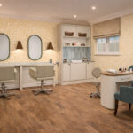 Artist's impression of the hair salon with styling chairs, mirrors and manicure table at Elland Court Care Home, Leeds
