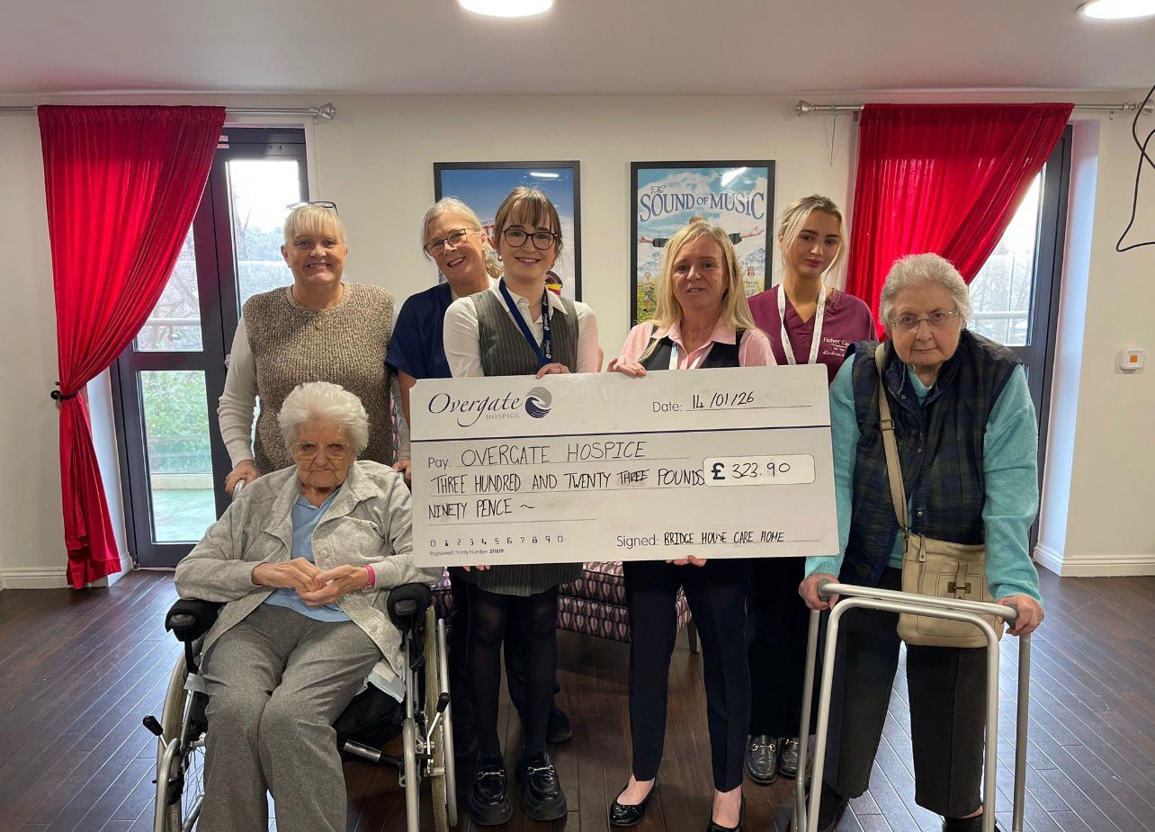 Residents and staff holding a £323.90 cheque for Overgate Hospice at Bridge House Care Home, Brighouse