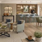 Artist's impression of the café bar with bar stools, armchairs and dining tables at Elland Court Care Home, Leeds