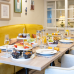 Afternoon tea with scones, muffins and fruit laid out in the bistro at The Maltings Care Home, Bridlington