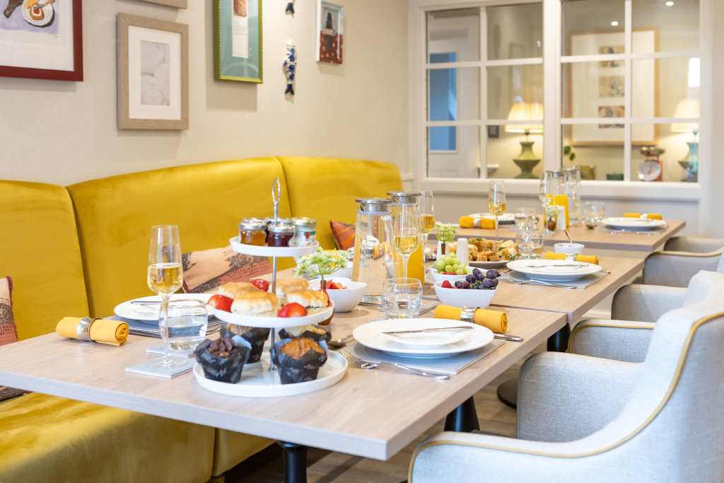 Afternoon tea with scones, muffins and fruit laid out in the bistro at The Maltings Care Home, Bridlington