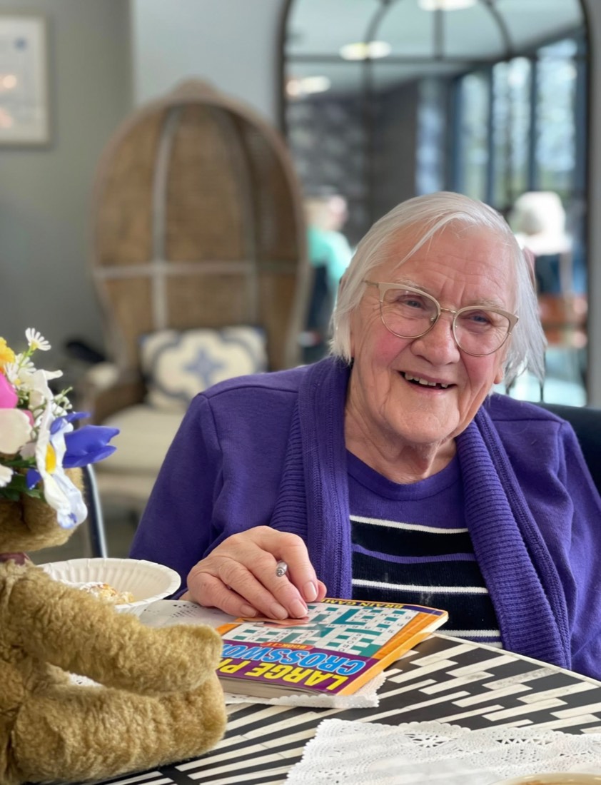 Smiling resident working on a large-print crossword at The Maltings Care Home, Bridlington Smiling resident working on a large-print crossword at The Maltings Care Home, Bridlington