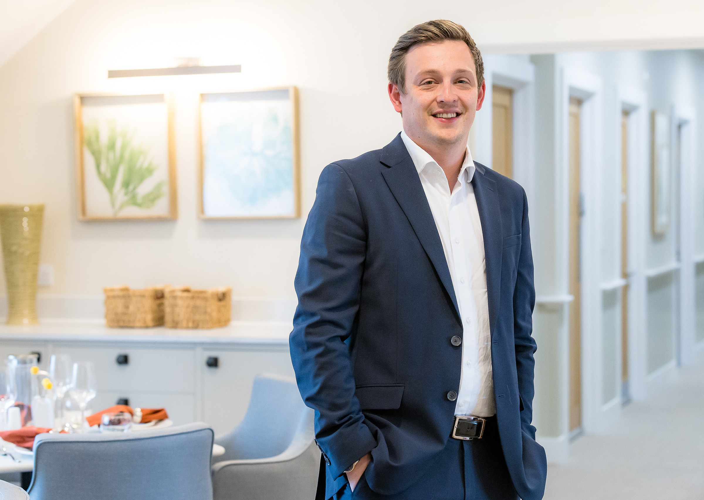 Josh Fisher, Managing Director of Fisher Care Group, standing in a care home dining room