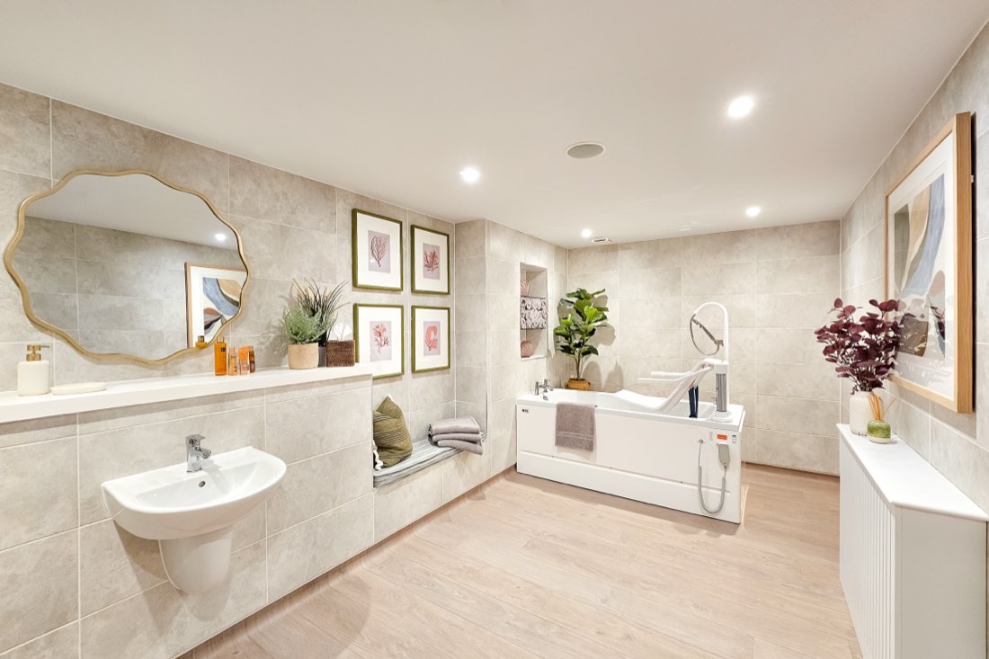 Spa bathroom with an assisted bath and transfer seat, basin and gold mirror at The Maltings Care Home, Bridlington Spa bathroom with an assisted bath and transfer seat, basin and gold mirror at The Maltings Care Home, Bridlington