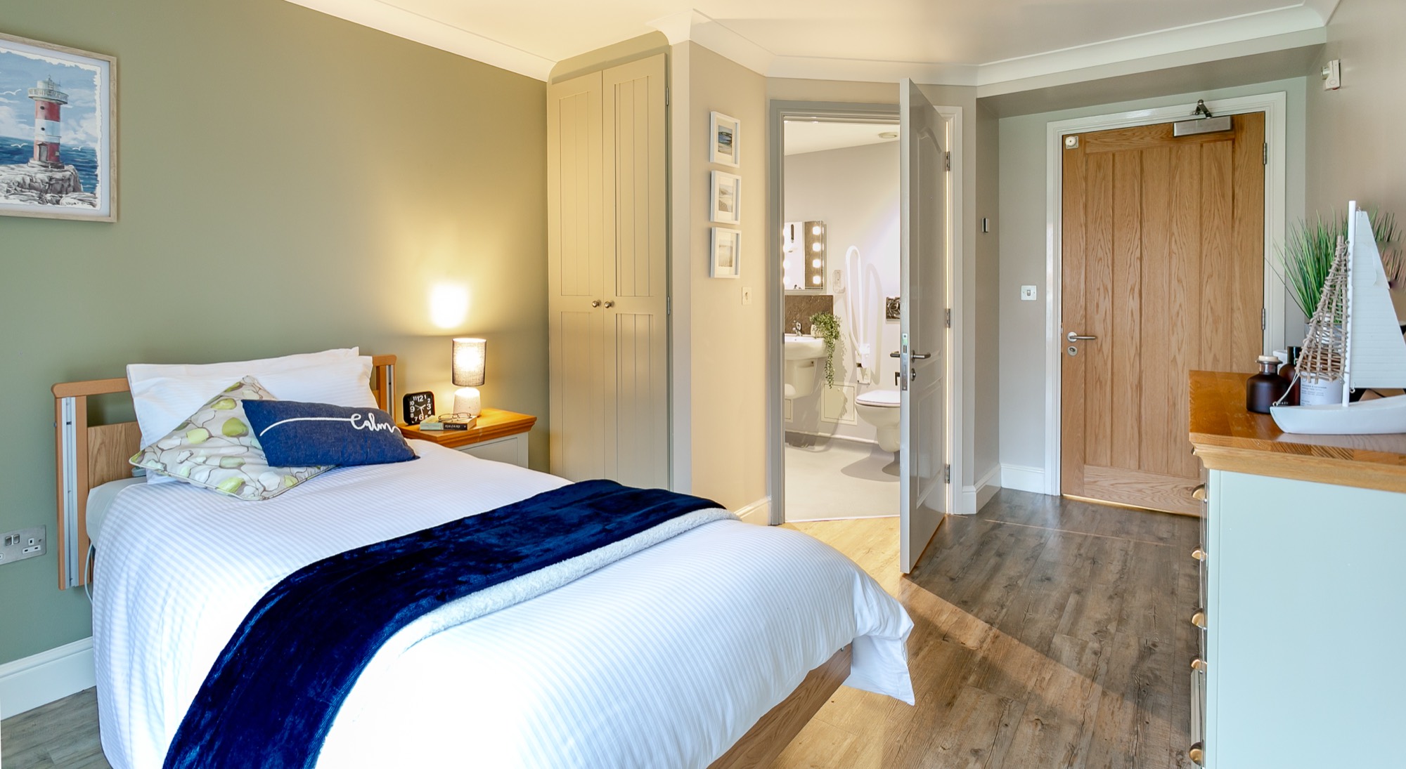 Bedroom with single bed and open en-suite door at Whitby Court Care Home, Whitby